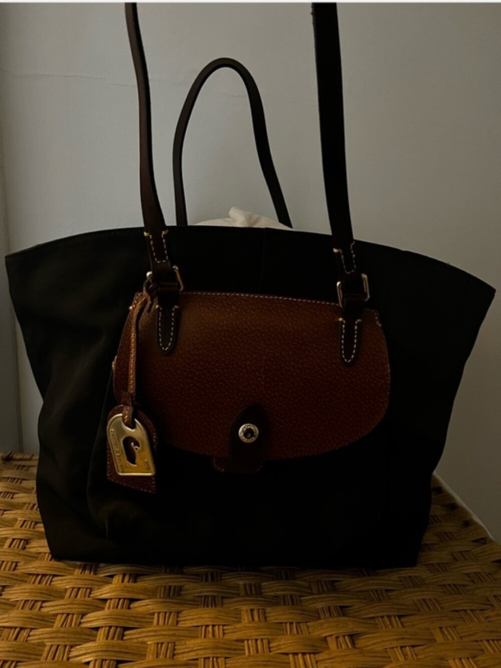 Dooney & Bourke Classic Black Tote with Brown Leather Flap.. Spots On Interior.